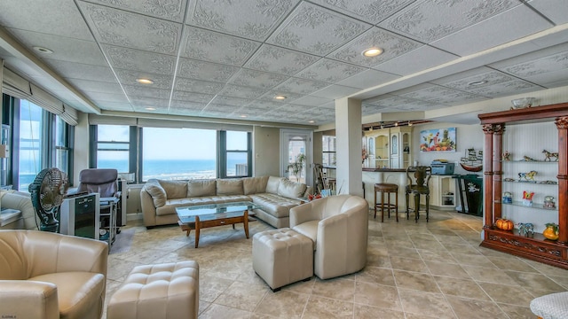 tiled living room featuring a water view