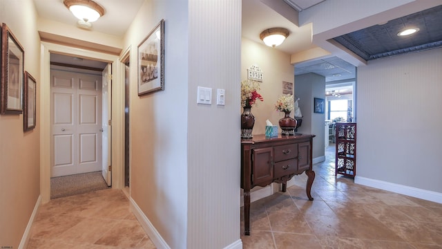 hall featuring light tile patterned flooring