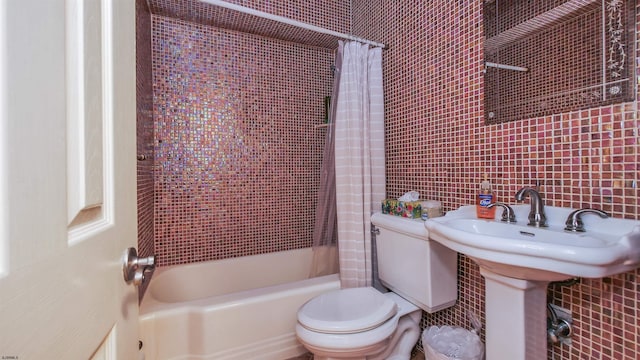 bathroom with toilet, tile walls, and shower / bath combination with curtain