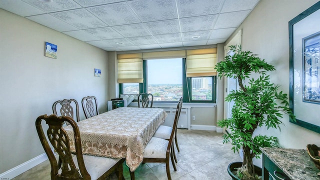 dining room featuring radiator and tile patterned flooring