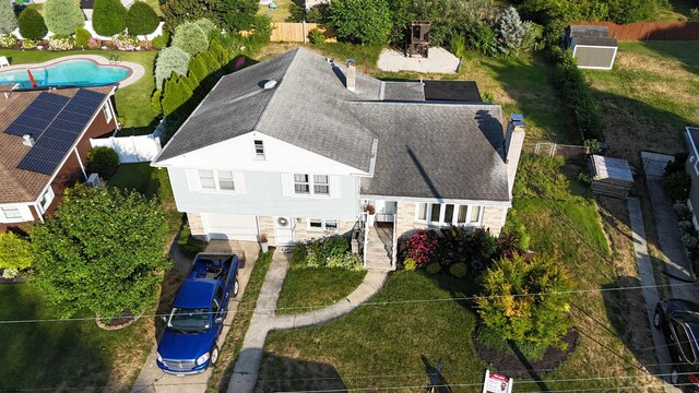 view of property exterior featuring a garage and a lawn