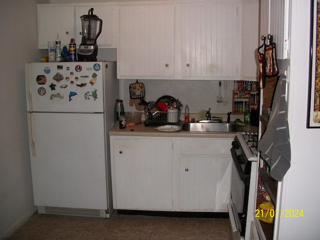 kitchen featuring white appliances and sink