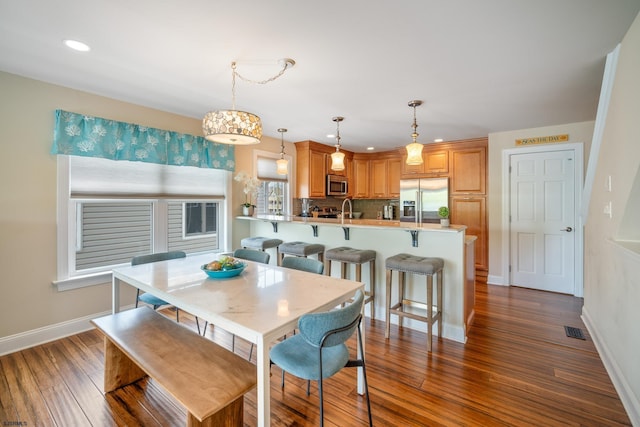 dining room featuring dark hardwood / wood-style flooring and sink