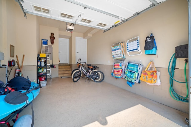 garage with a garage door opener and electric panel