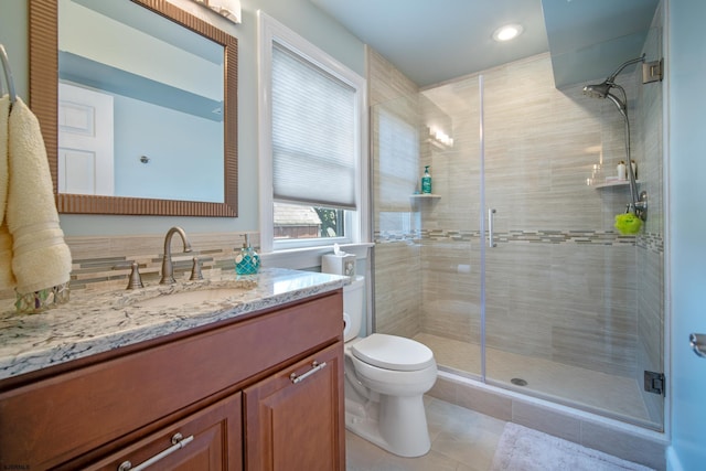 bathroom with vanity, an enclosed shower, tile patterned floors, and toilet