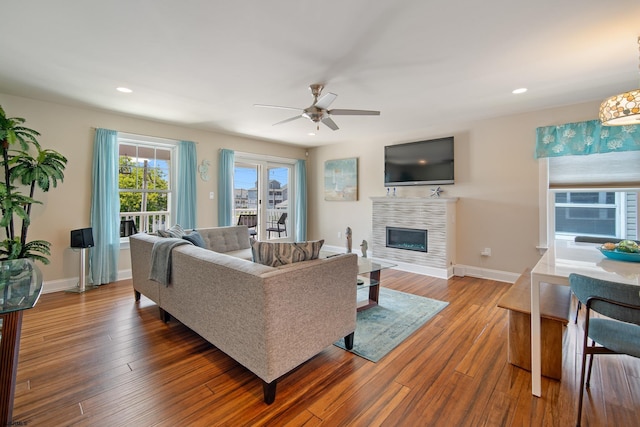 living room featuring wood-type flooring and ceiling fan