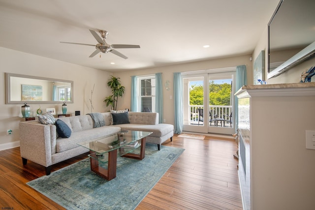 living room with hardwood / wood-style floors and ceiling fan