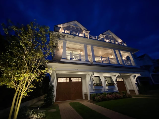 view of front of property with a balcony and a garage