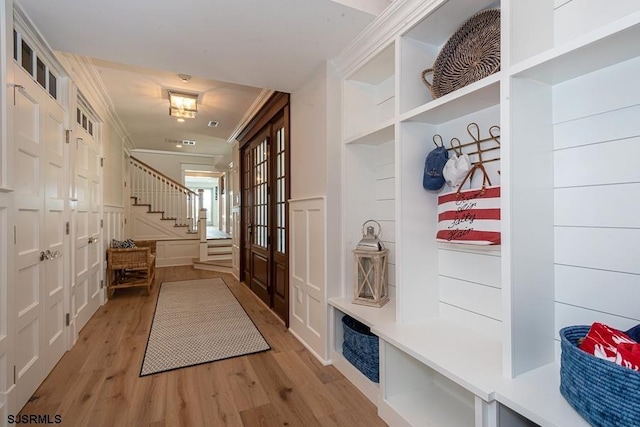 mudroom featuring hardwood / wood-style flooring, crown molding, and french doors