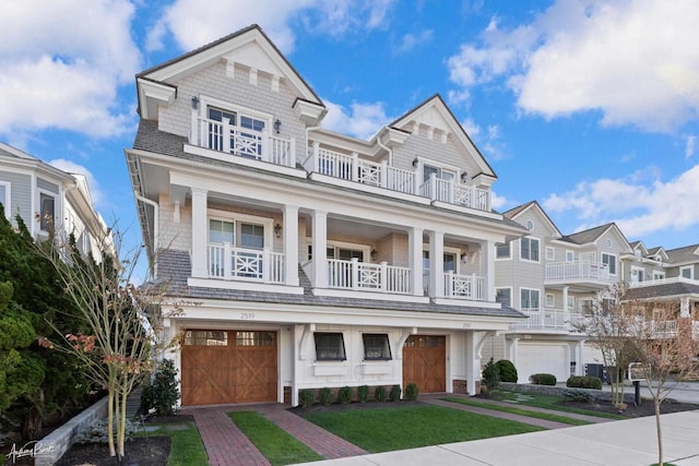 multi unit property featuring a balcony and a garage