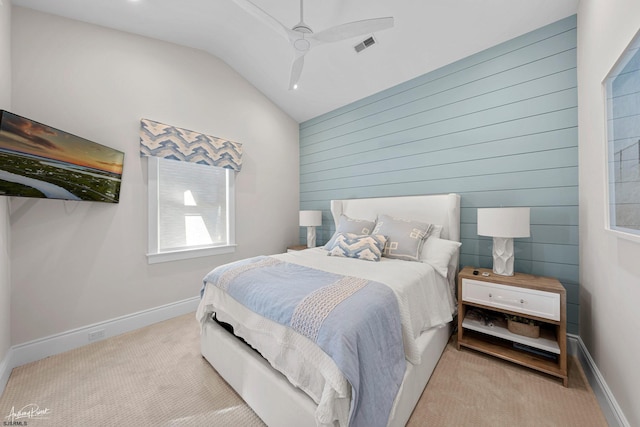 bedroom featuring lofted ceiling, light colored carpet, and ceiling fan