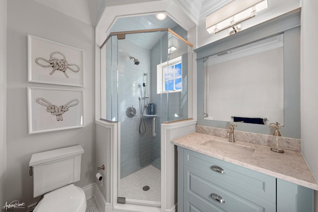 bathroom featuring toilet, vanity, and a shower with door