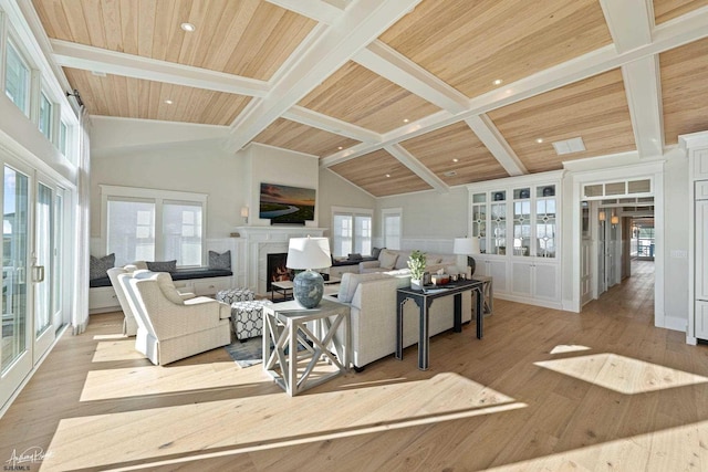 living room with a wealth of natural light, wood ceiling, and beam ceiling