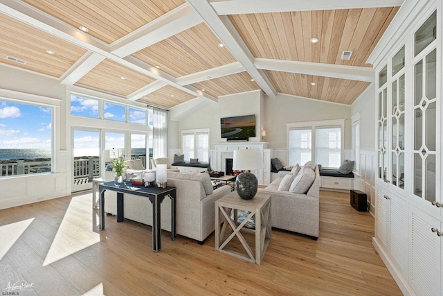 living room with light wood-type flooring, wooden ceiling, and plenty of natural light