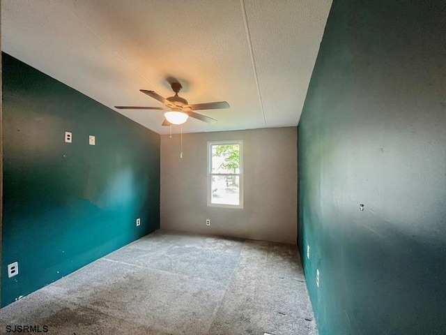 spare room with ceiling fan and carpet floors