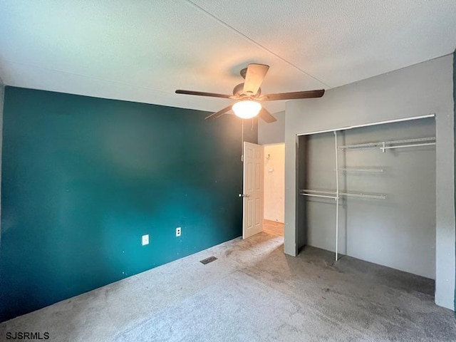 unfurnished bedroom with ceiling fan, a closet, carpet, and a textured ceiling