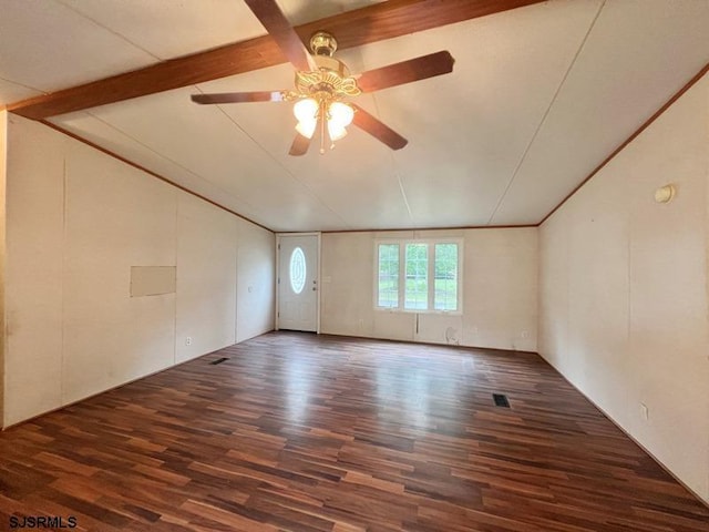 unfurnished room featuring ceiling fan, dark hardwood / wood-style flooring, and beam ceiling