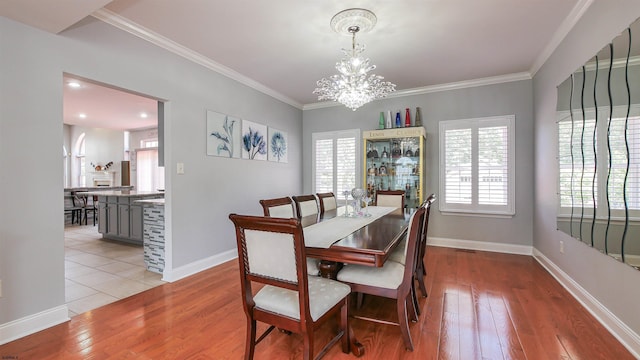 dining area featuring a notable chandelier, plenty of natural light, and light wood-type flooring