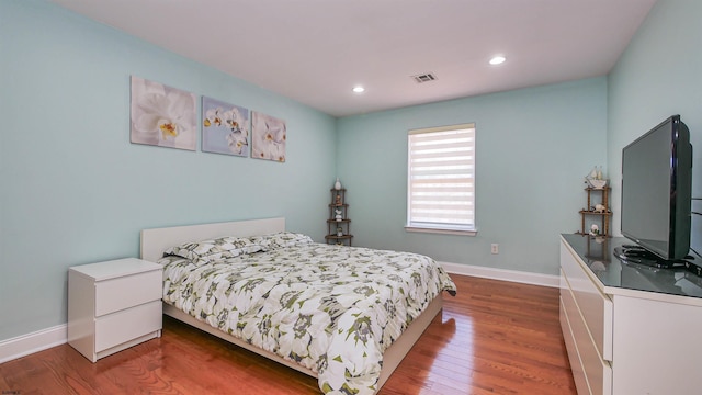 bedroom with hardwood / wood-style floors