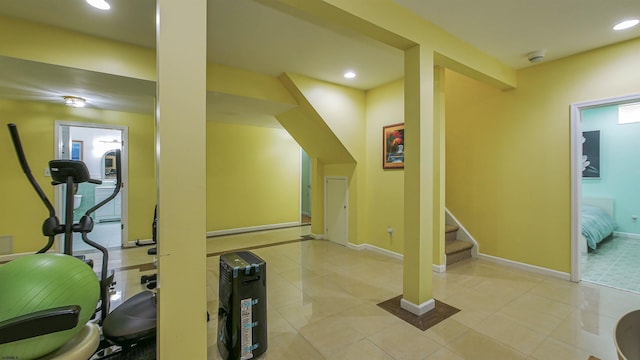 exercise area featuring light tile patterned flooring