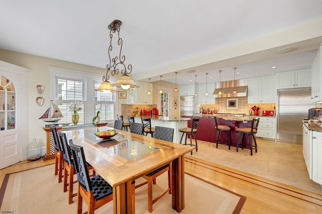 dining space with light wood-type flooring and recessed lighting