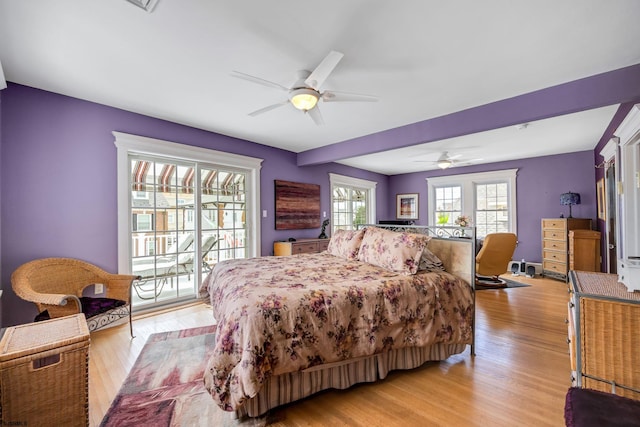 bedroom featuring light wood-type flooring, access to outside, and ceiling fan