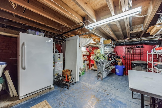 unfinished basement featuring water heater and freestanding refrigerator