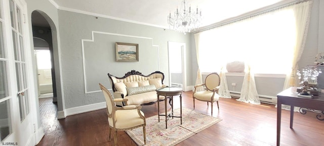 sitting room with crown molding, a baseboard radiator, dark hardwood / wood-style flooring, and a chandelier