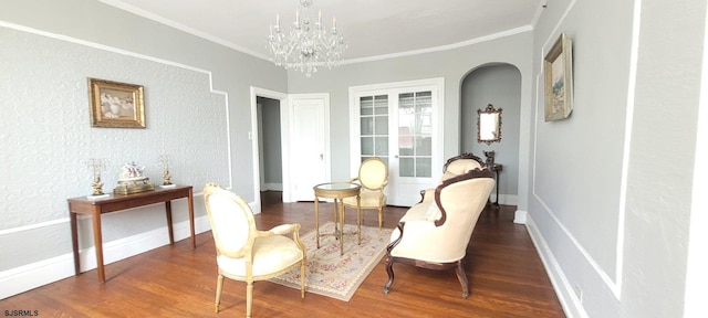 sitting room featuring an inviting chandelier, hardwood / wood-style floors, and ornamental molding