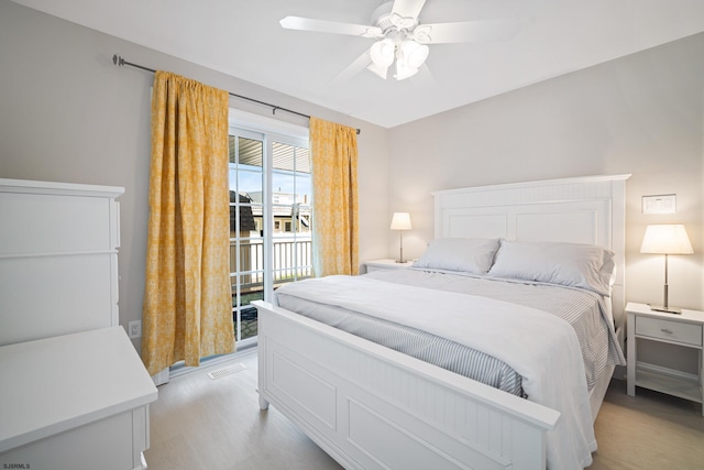 bedroom with light hardwood / wood-style flooring, ceiling fan, and access to exterior