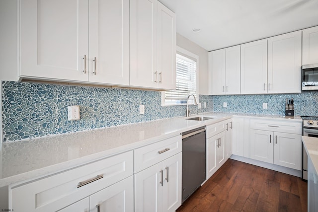 kitchen featuring sink, appliances with stainless steel finishes, dark hardwood / wood-style floors, and white cabinets