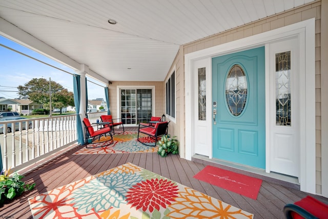 view of exterior entry with a porch