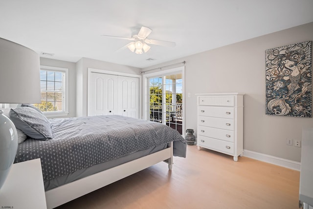 bedroom featuring light hardwood / wood-style flooring, a closet, access to outside, and ceiling fan