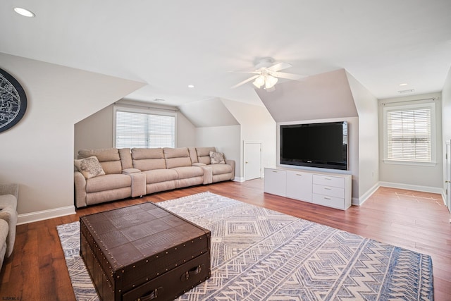 living room featuring lofted ceiling, hardwood / wood-style flooring, and ceiling fan