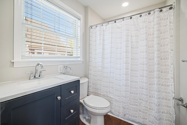 bathroom featuring hardwood / wood-style floors, toilet, and vanity