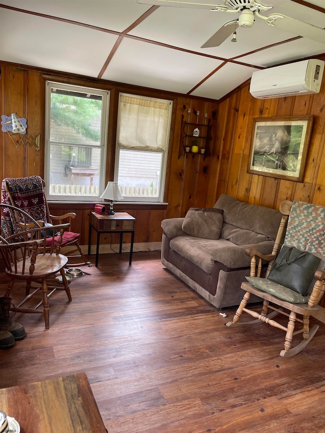 living room with a wall unit AC, wood walls, dark hardwood / wood-style floors, and ceiling fan