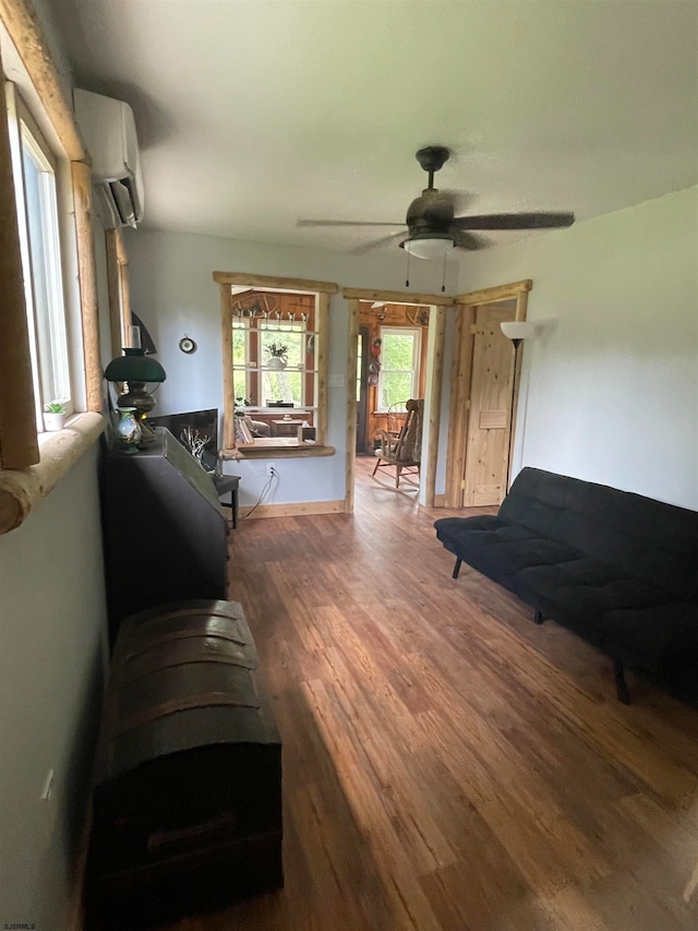 living room featuring hardwood / wood-style flooring and ceiling fan