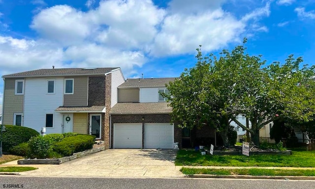 view of front of house featuring a garage and a front lawn