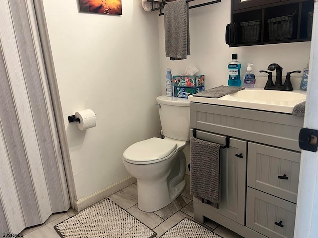 bathroom with tile patterned floors, vanity, and toilet