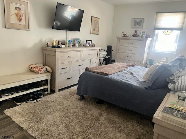 bedroom with dark hardwood / wood-style floors