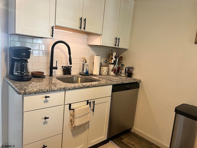 kitchen with dishwasher, dark hardwood / wood-style floors, backsplash, and white cabinetry