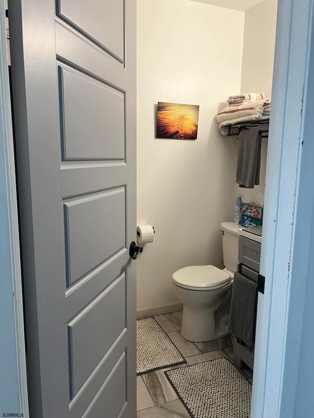 bathroom with vanity, toilet, and tile patterned flooring