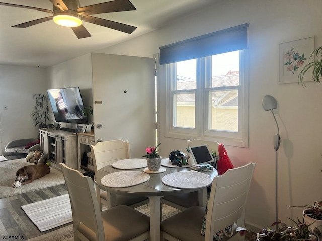 dining area with ceiling fan and hardwood / wood-style flooring