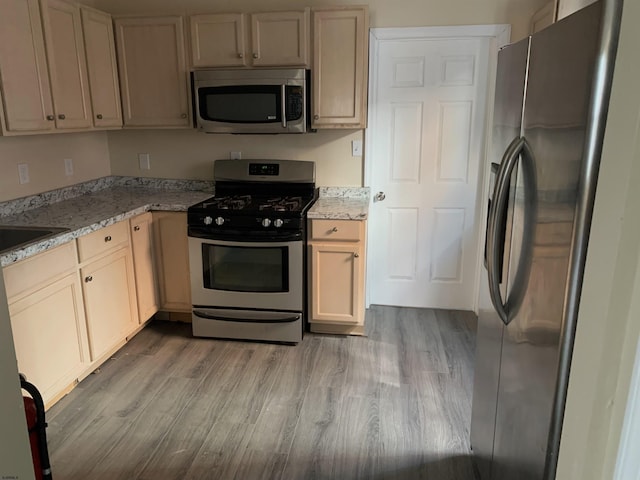 13 Vola Ln, Pleasantville, NJ 08232 - kitchen featuring appliances with stainless steel finishes, wood finished floors, and light stone counters
