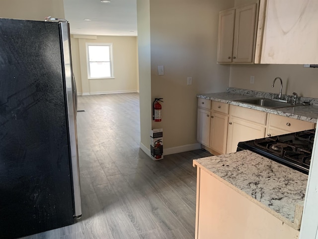 13 Vola Ln, Pleasantville, NJ 08232 - kitchen with freestanding refrigerator, light wood-style floors, baseboards, black range with gas stovetop, and a sink