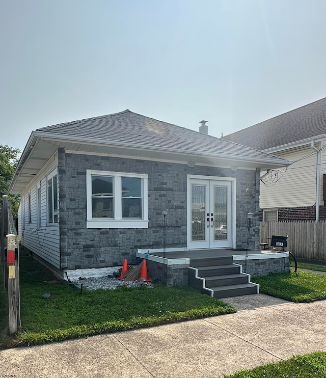 view of front of property featuring french doors and a front yard