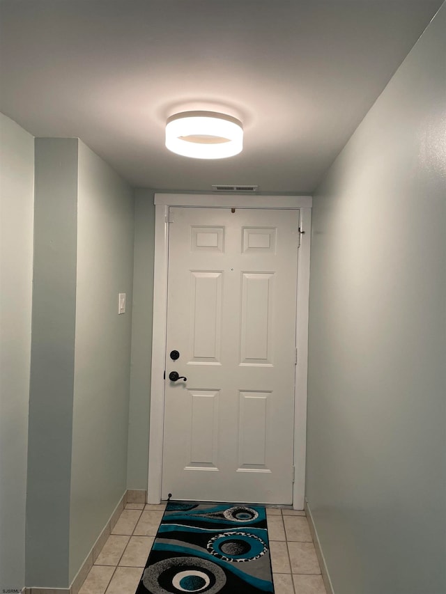 doorway with light tile patterned floors