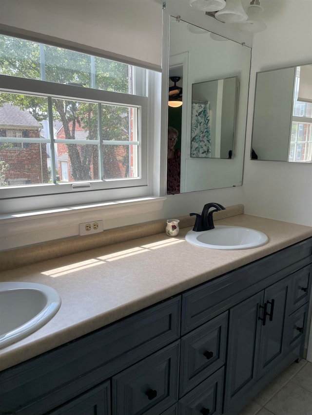 bathroom with vanity, tile patterned floors, and a wealth of natural light