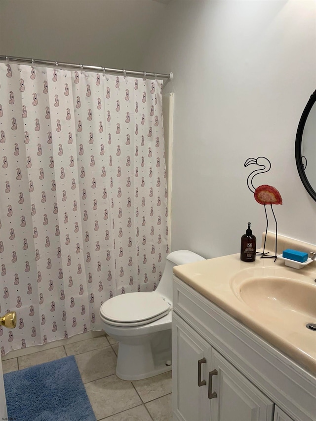 bathroom featuring tile patterned flooring, toilet, and vanity