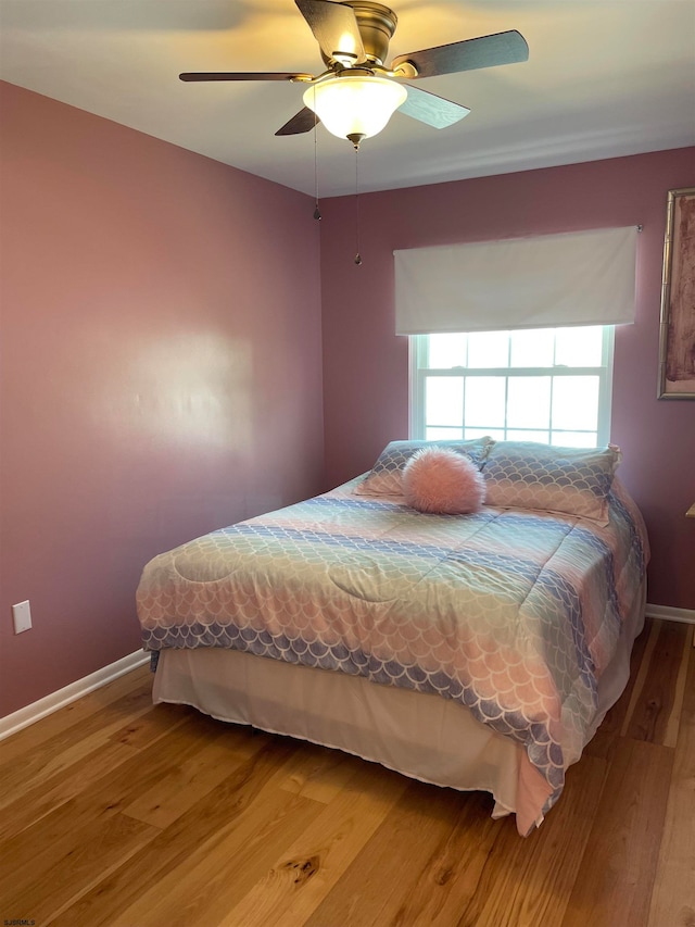 bedroom with hardwood / wood-style flooring and ceiling fan